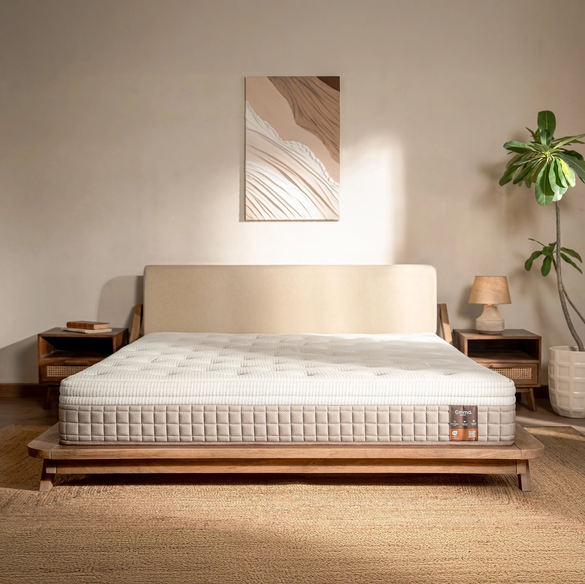 Mattress on a wooden bed frame in a bedroom setting with decor elements.